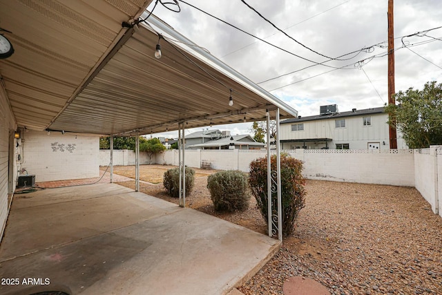 view of patio / terrace featuring a carport and a fenced backyard