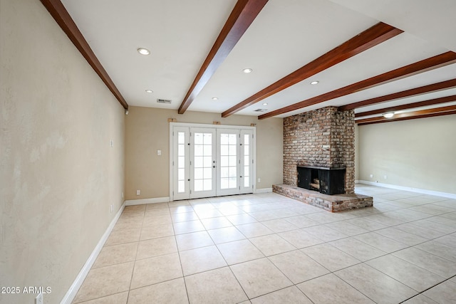 unfurnished living room with light tile patterned floors, visible vents, baseboards, french doors, and beam ceiling