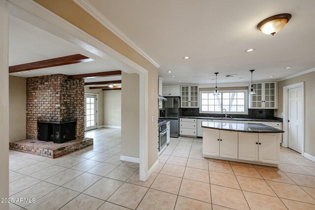 kitchen featuring freestanding refrigerator, light tile patterned flooring, glass insert cabinets, and white cabinetry