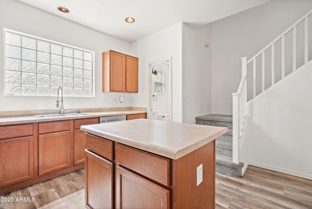 kitchen with a sink, light wood-style flooring, and light countertops