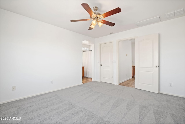 unfurnished bedroom featuring visible vents, baseboards, and carpet floors