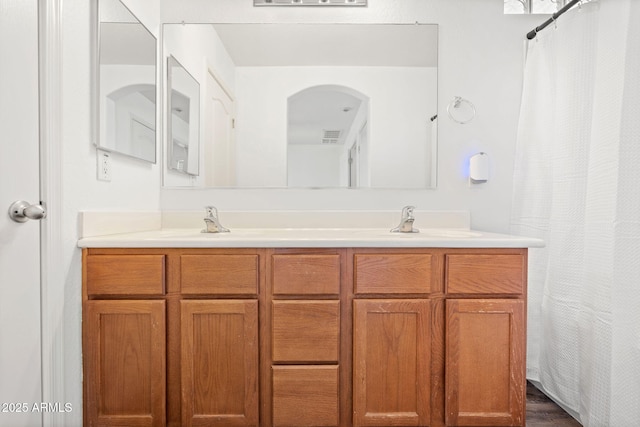 full bath featuring a sink and double vanity