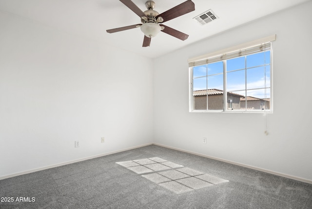 carpeted empty room with visible vents, ceiling fan, and baseboards