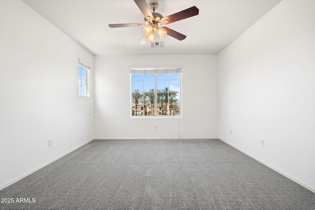 unfurnished room with visible vents, baseboards, a ceiling fan, and carpet floors