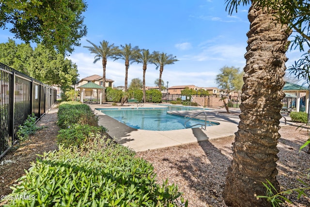 pool with a gazebo, fence, and a patio