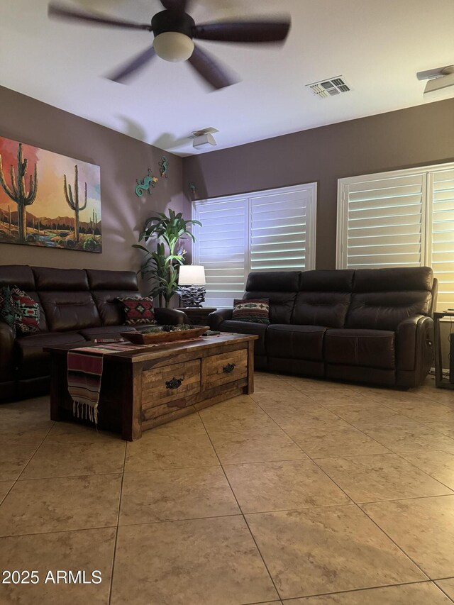 living area featuring ceiling fan, visible vents, and tile patterned flooring