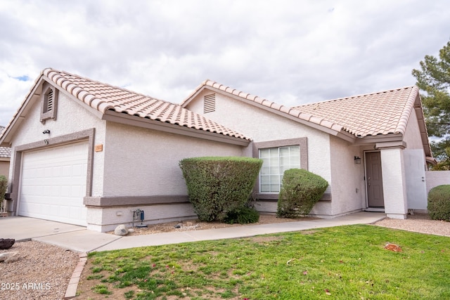 mediterranean / spanish-style house featuring stucco siding, a tile roof, concrete driveway, a front yard, and a garage