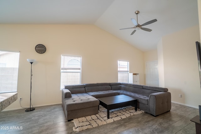 living room featuring baseboards, wood finished floors, high vaulted ceiling, and ceiling fan