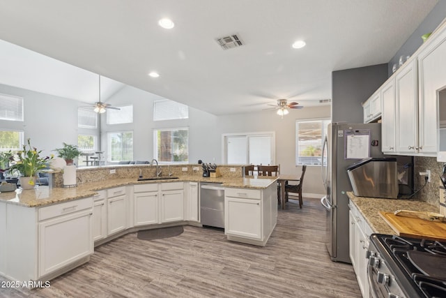 kitchen featuring stainless steel appliances, ceiling fan, visible vents, and a sink