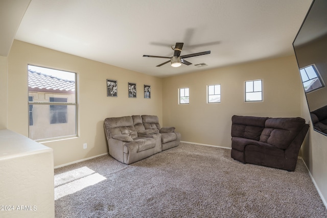 living room with carpet floors, ceiling fan, and a wealth of natural light