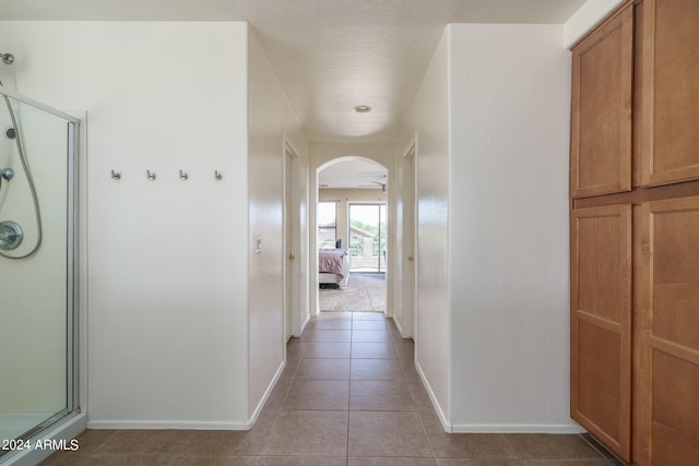 hallway featuring tile patterned flooring