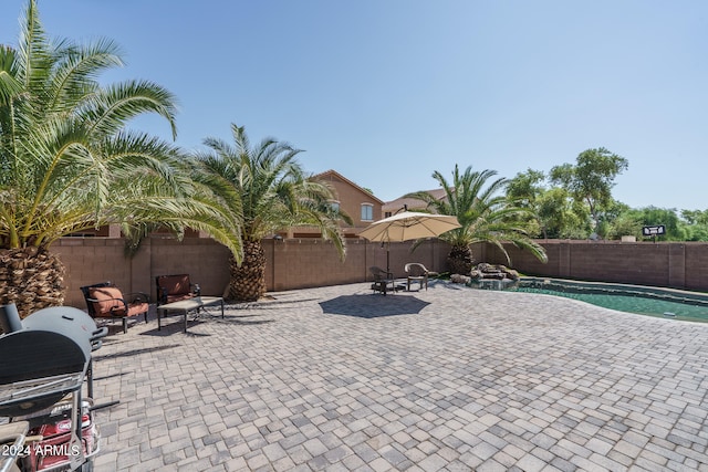 view of patio / terrace featuring grilling area and a fenced in pool