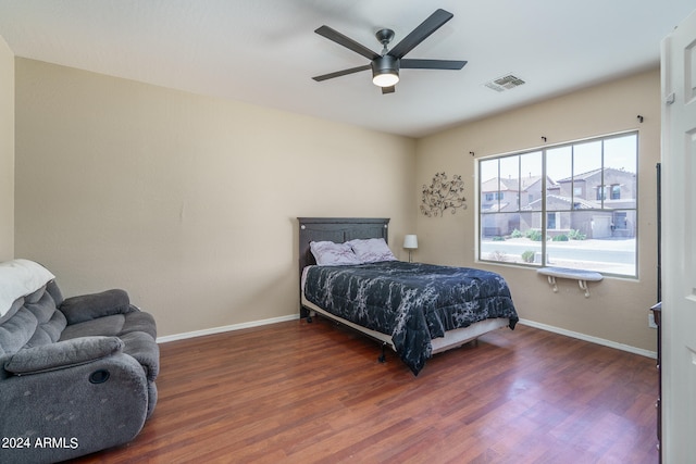 bedroom with dark hardwood / wood-style floors and ceiling fan