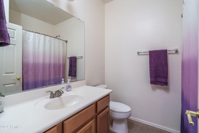 bathroom featuring tile patterned floors, vanity, and toilet