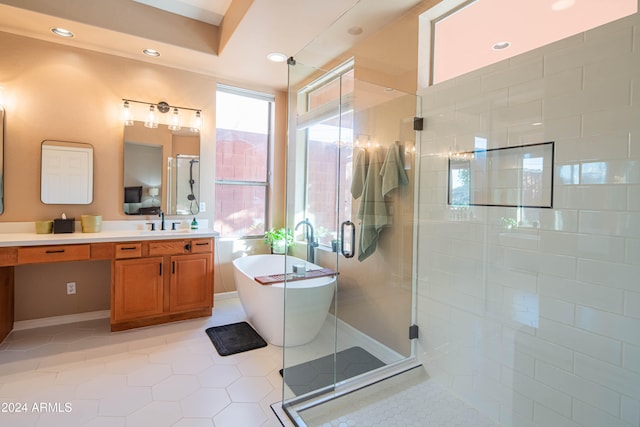 bathroom featuring tile patterned flooring, separate shower and tub, and vanity