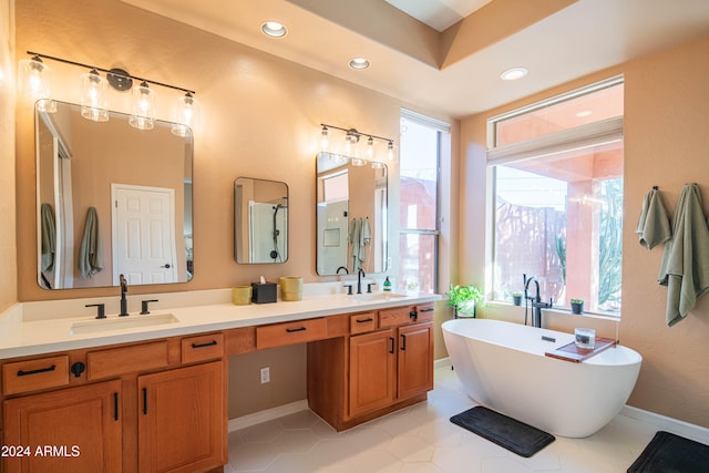 bathroom with a bathtub, tile patterned floors, and vanity