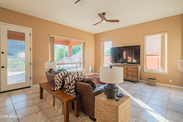 tiled living room featuring ceiling fan