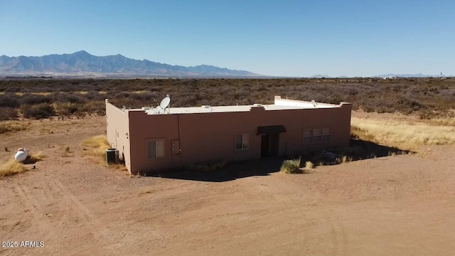 view of storm shelter featuring a mountain view and central AC