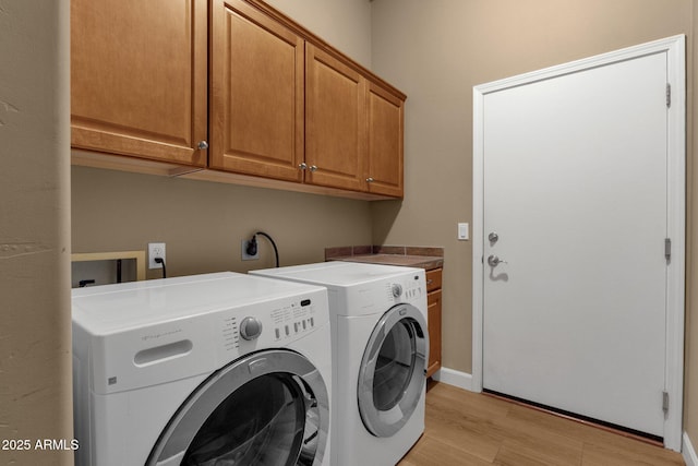 10254 N Demaret Dr, Fountain Hills, AZ 85268 - laundry room with cabinets, washing machine and dryer, and light hardwood / wood-style flooring
