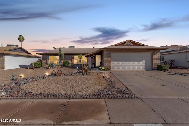 view of front of house with brick siding, concrete driveway, and an attached garage