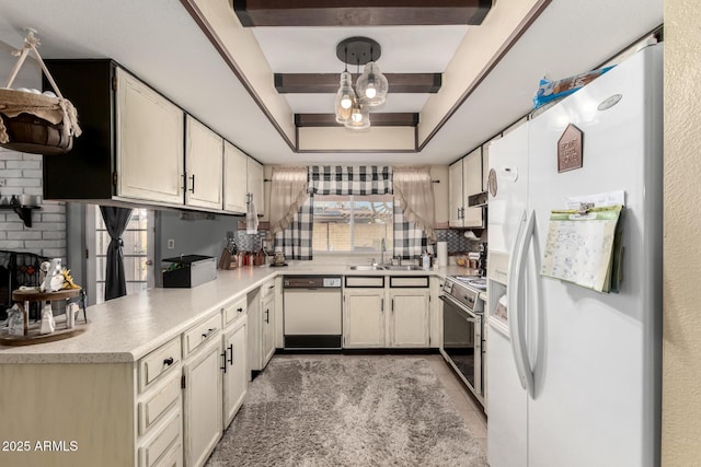 kitchen with white appliances, a tray ceiling, a sink, decorative backsplash, and light countertops