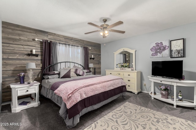 bedroom featuring wooden walls, carpet flooring, and a ceiling fan