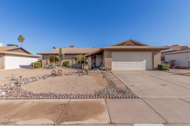 ranch-style house with brick siding, driveway, and an attached garage