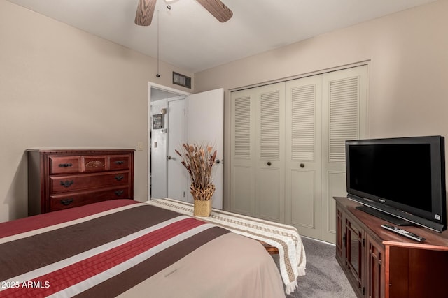 carpeted bedroom with visible vents, a closet, and ceiling fan