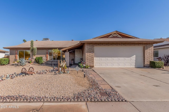 ranch-style home featuring concrete driveway and a garage