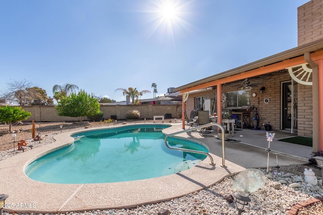 view of swimming pool with a fenced in pool, a patio, a ceiling fan, and a fenced backyard