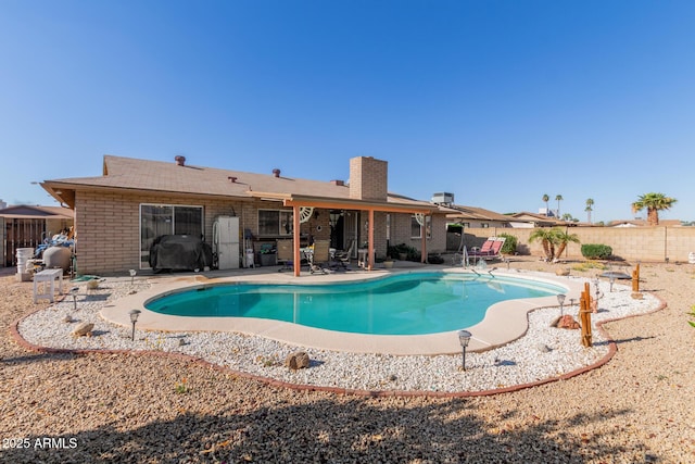 view of swimming pool with a patio, a fenced backyard, a fenced in pool, and grilling area