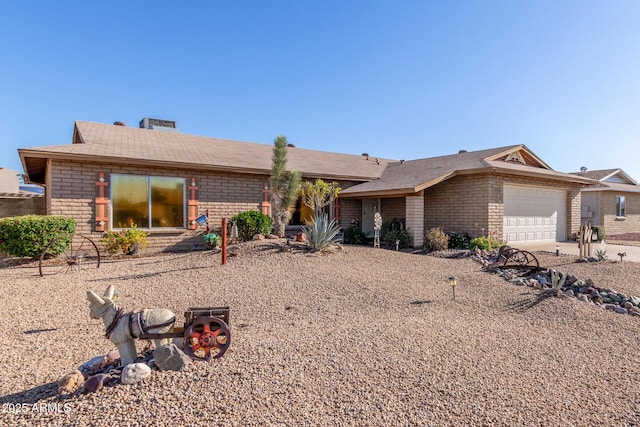 ranch-style house featuring an attached garage and concrete driveway