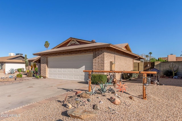 ranch-style home featuring concrete driveway, a garage, and fence