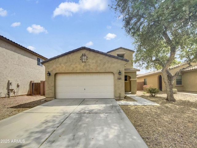view of front of property with stucco siding, an attached garage, concrete driveway, and a tile roof