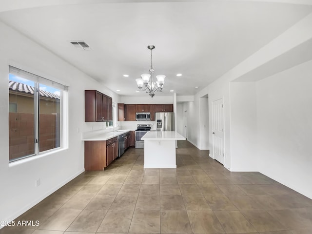 kitchen featuring a sink, an inviting chandelier, light countertops, appliances with stainless steel finishes, and visible vents