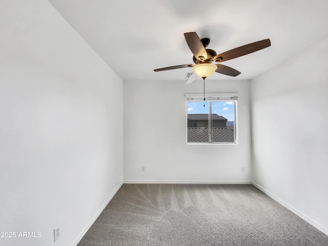 spare room featuring baseboards, a ceiling fan, and carpet