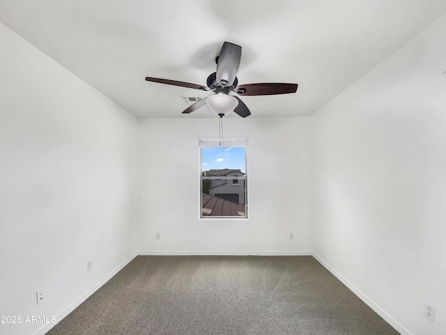empty room with a ceiling fan, baseboards, and dark carpet