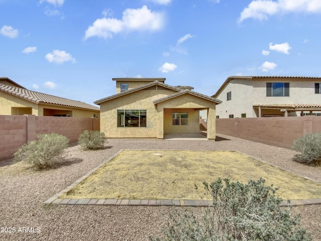 back of house featuring a patio area, a fenced backyard, and stucco siding