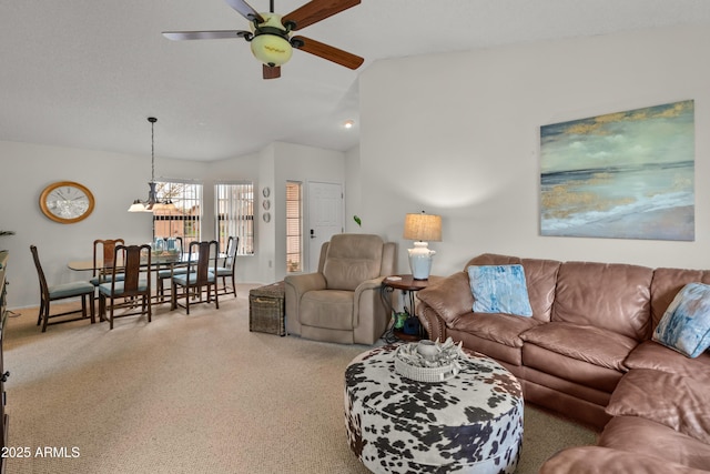 carpeted living room featuring lofted ceiling and a ceiling fan