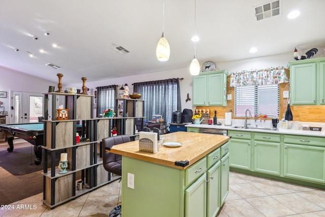 kitchen with pendant lighting, a center island, green cabinetry, and sink