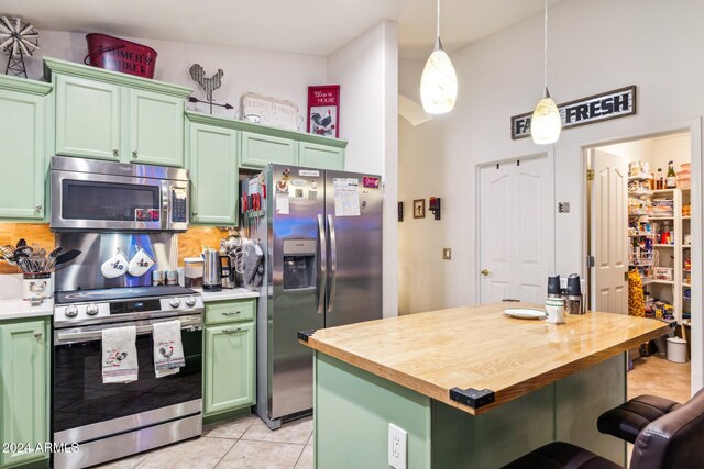 kitchen with stainless steel appliances and green cabinetry