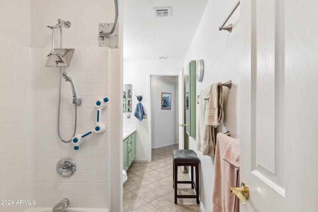 bathroom featuring tile patterned floors, vanity, and tiled shower / bath