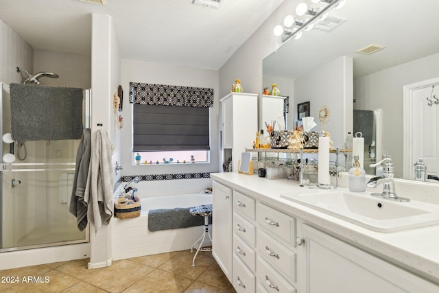 bathroom featuring tile patterned flooring, vanity, and plus walk in shower