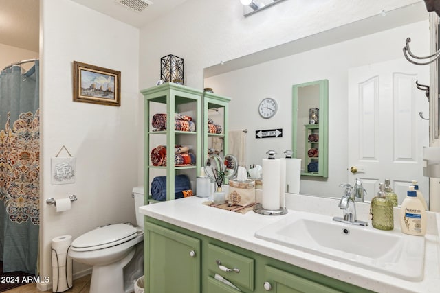 bathroom featuring vanity, curtained shower, and toilet