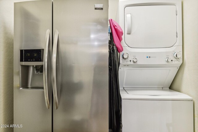 laundry room with stacked washer / drying machine