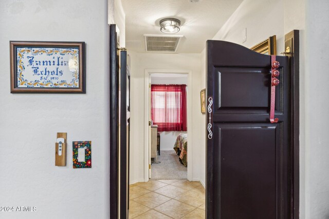 hall featuring light tile patterned floors