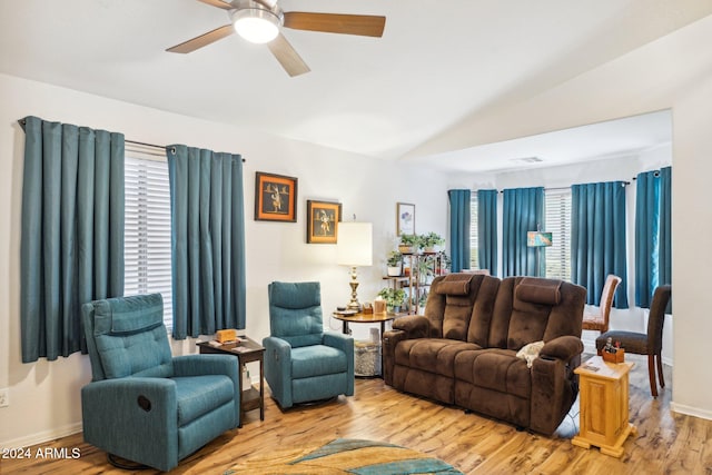 living room with hardwood / wood-style floors, ceiling fan, and lofted ceiling