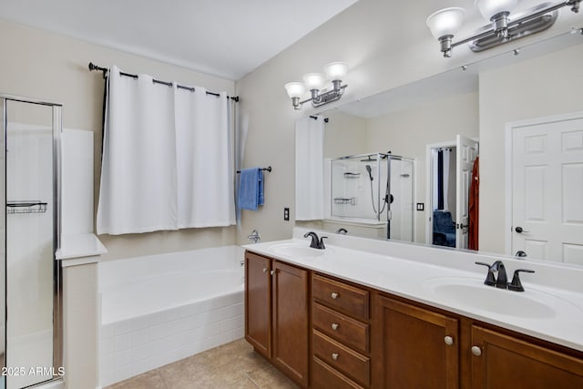 full bath featuring tile patterned flooring, a garden tub, a stall shower, and a sink