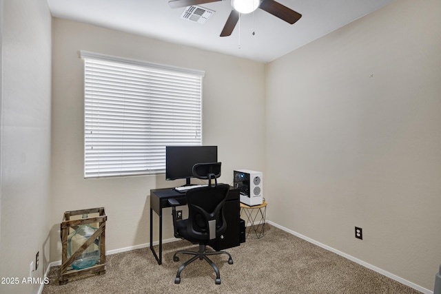 office space featuring baseboards, carpet floors, visible vents, and a ceiling fan