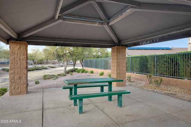 surrounding community featuring fence, outdoor dining space, and a patio area